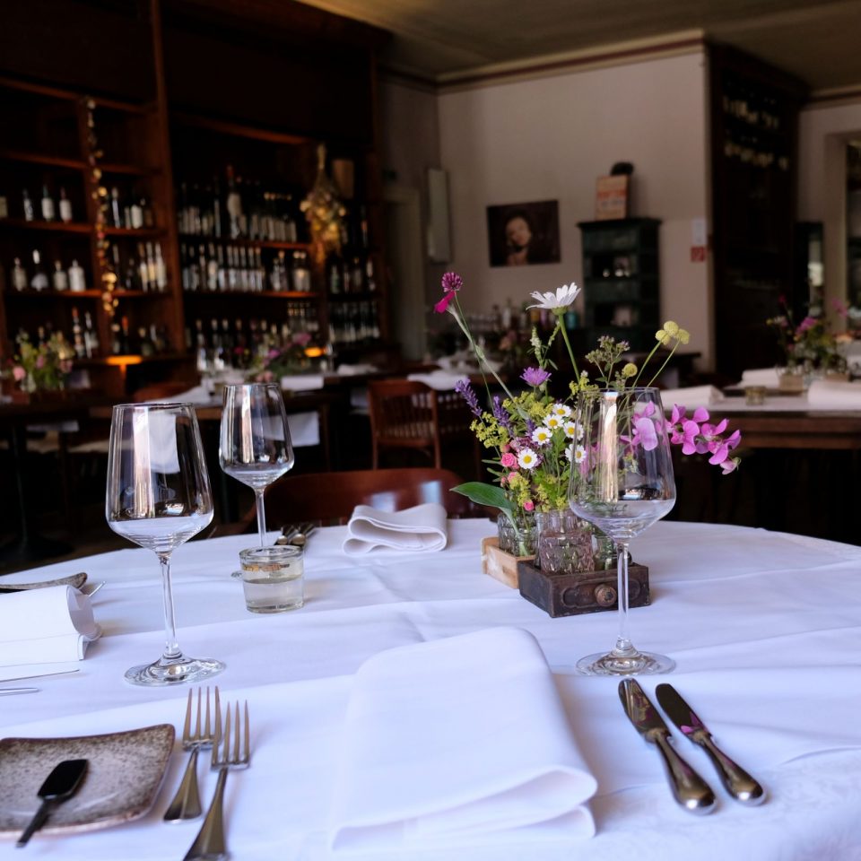 A laid table is ready in the restaurant and awaits the first guests of the evening